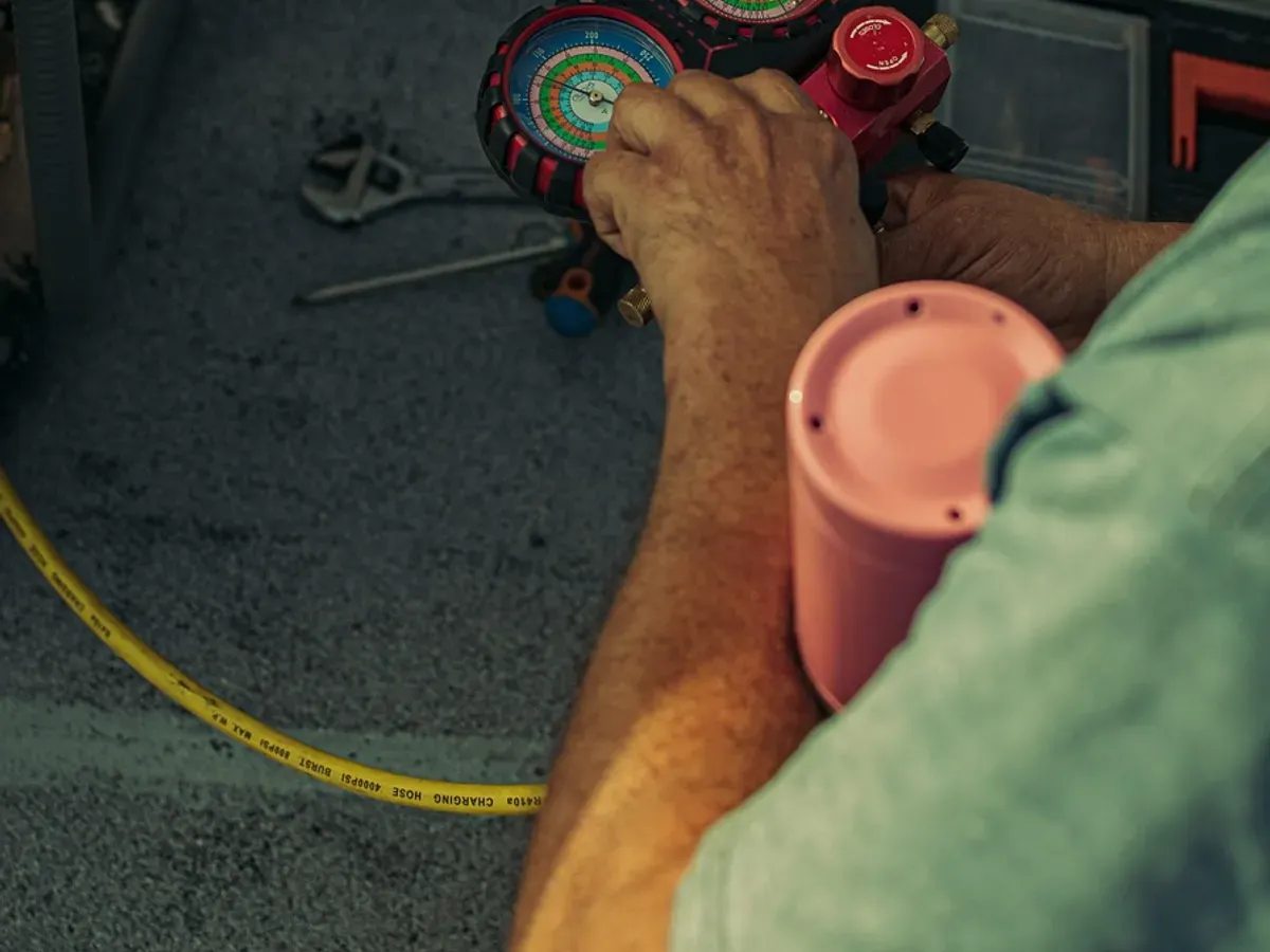 A service technician checking an air-conditioning system